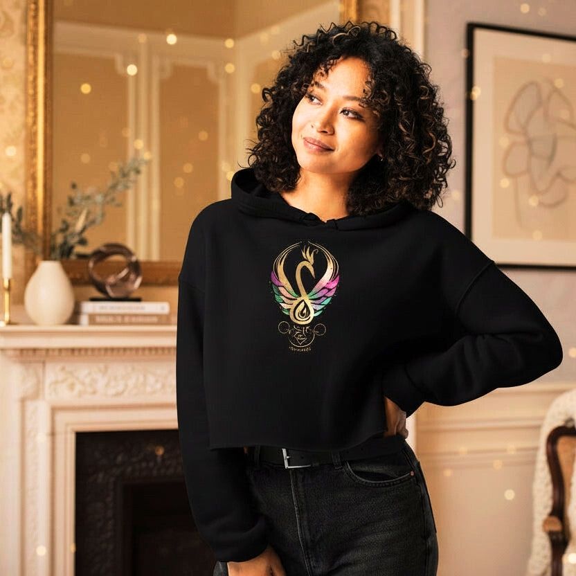 Woman wearing black cropped hoodie with Mystic Glow swan symbol, Celtic Swan Collection.
