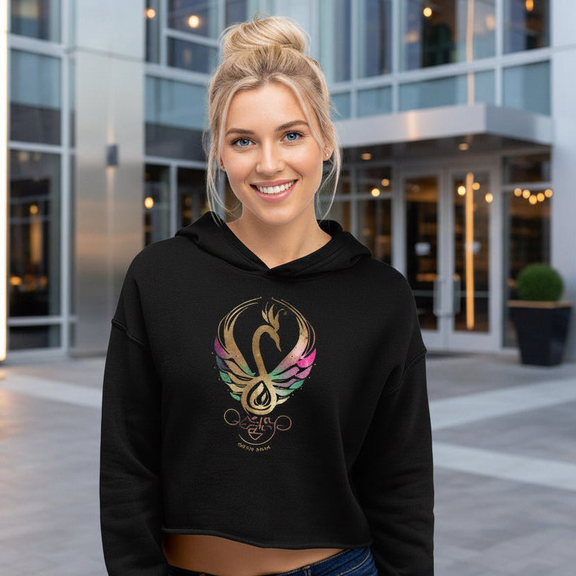 Woman wearing black cropped hoodie with Mystic Glow swan symbol, Celtic Swan Collection. Urban background.